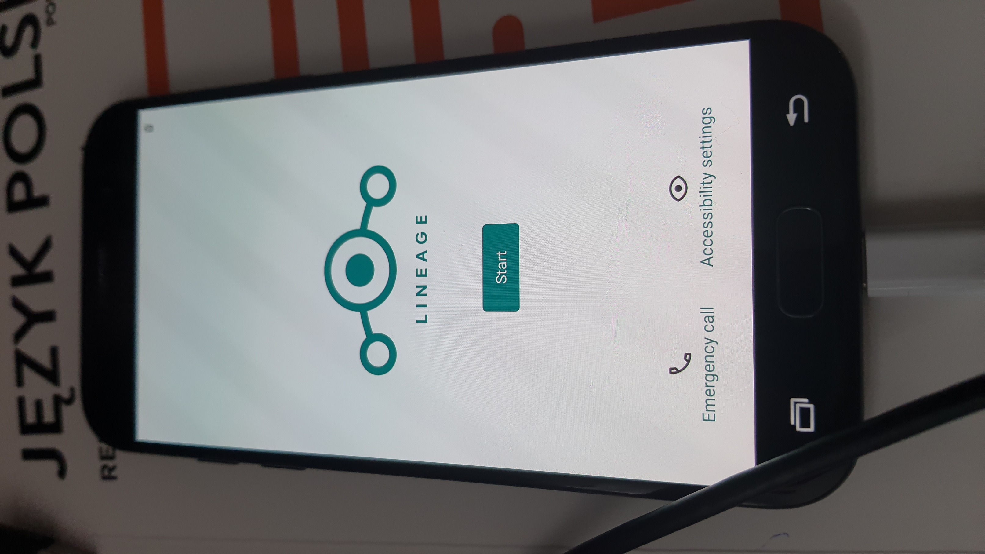 the same smartphone, showing the boot splash screen for LineageOS.